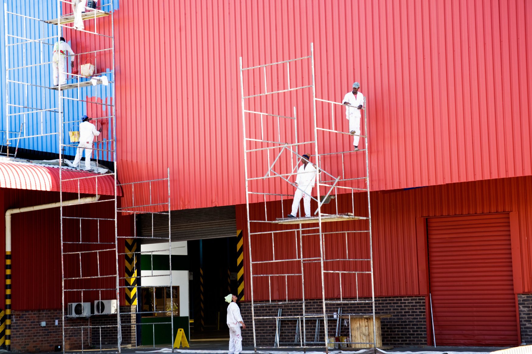 Industrial painters painting factory